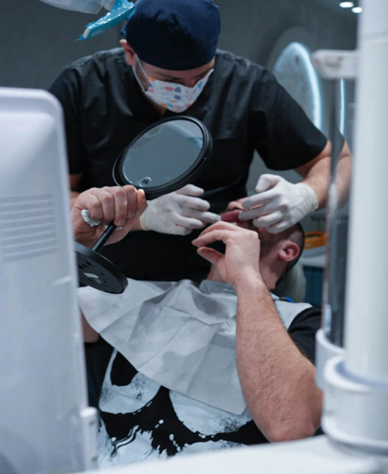 Pacient cu oglindă de mână, alături de medicul AVI în cabinet